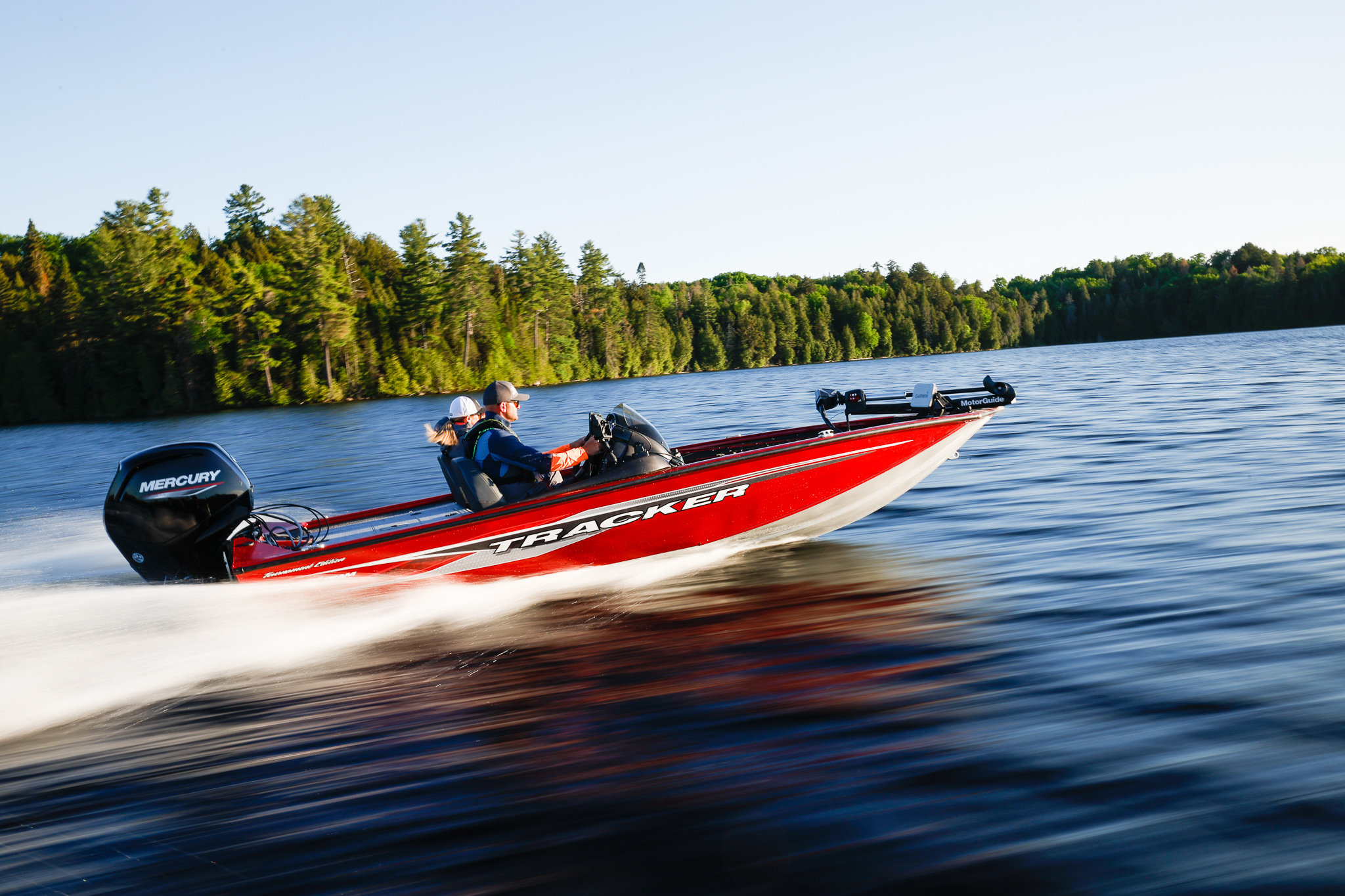 Two people in a fast-moving fishing boat, aluminum vs fiberglass boats concept. 